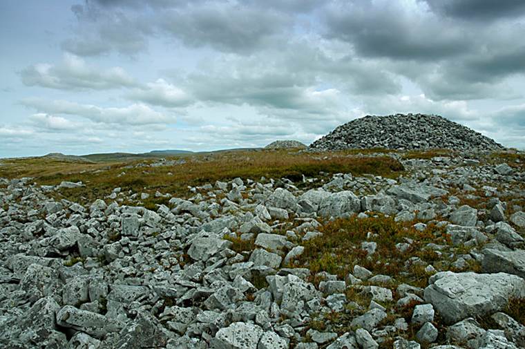 A rocky landscape with a pile of rocks
Description automatically generated