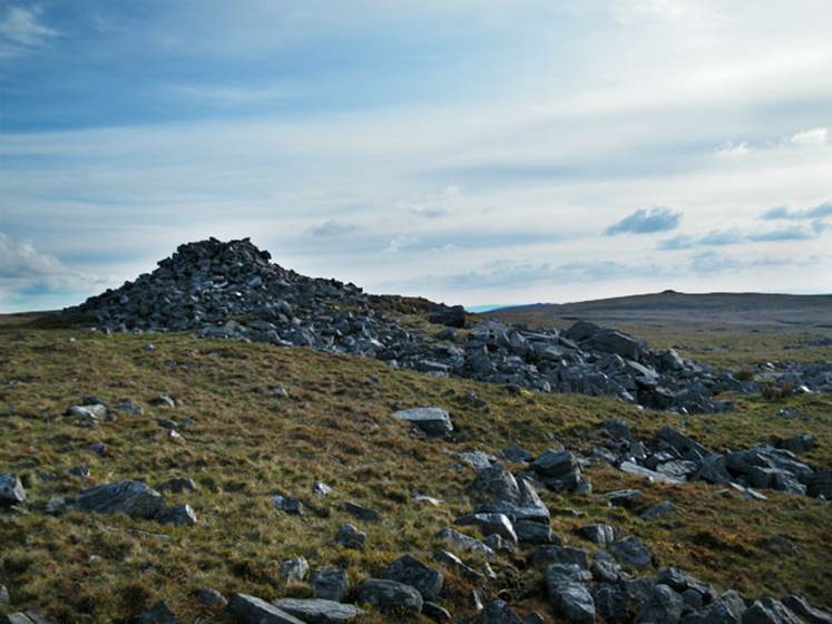 A pile of rocks on a hill
Description automatically generated