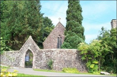 A stone building with a gate
Description automatically generated